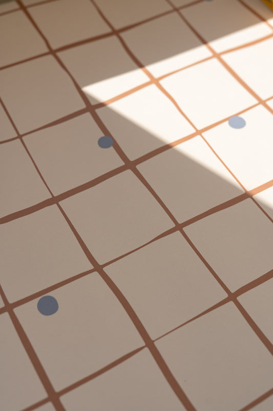 Matuu Pebble Grid wallpaper in cream – close-up with natural light and texture visible