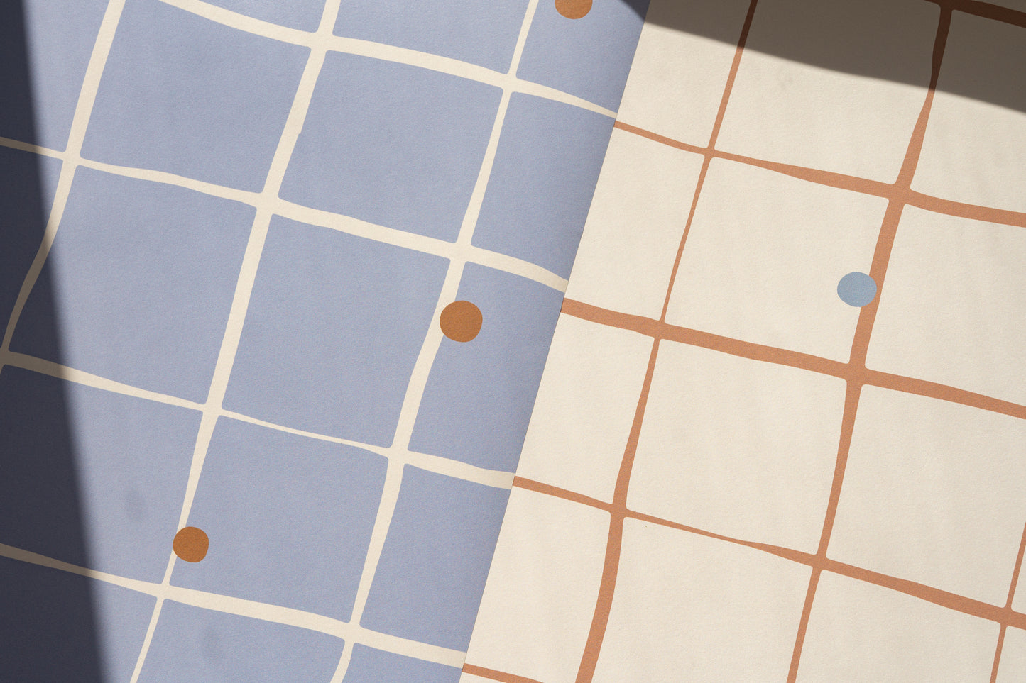 Detailed view of Matuu Pebble Grid wallpaper – dusty blue background with brown grid and blue dots