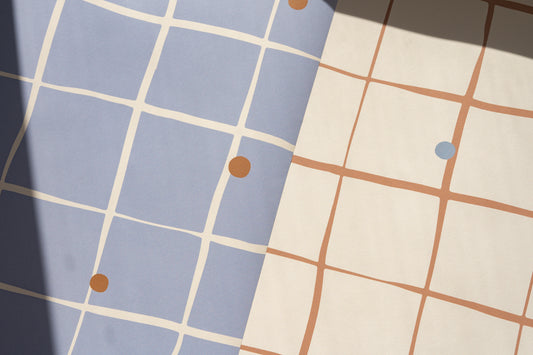 Detailed view of Matuu Pebble Grid wallpaper – dusty blue background with brown grid and blue dots