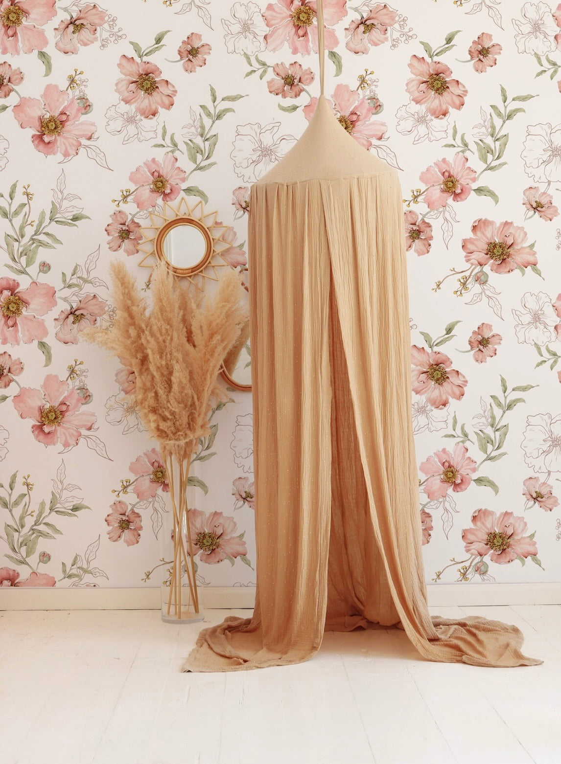 Matuu Blush Botanical wallpaper in a cozy nursery with a beige canopy and natural decor