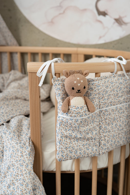 bed pocket – soft cotton with tiny blue flowers, tied to the crib
