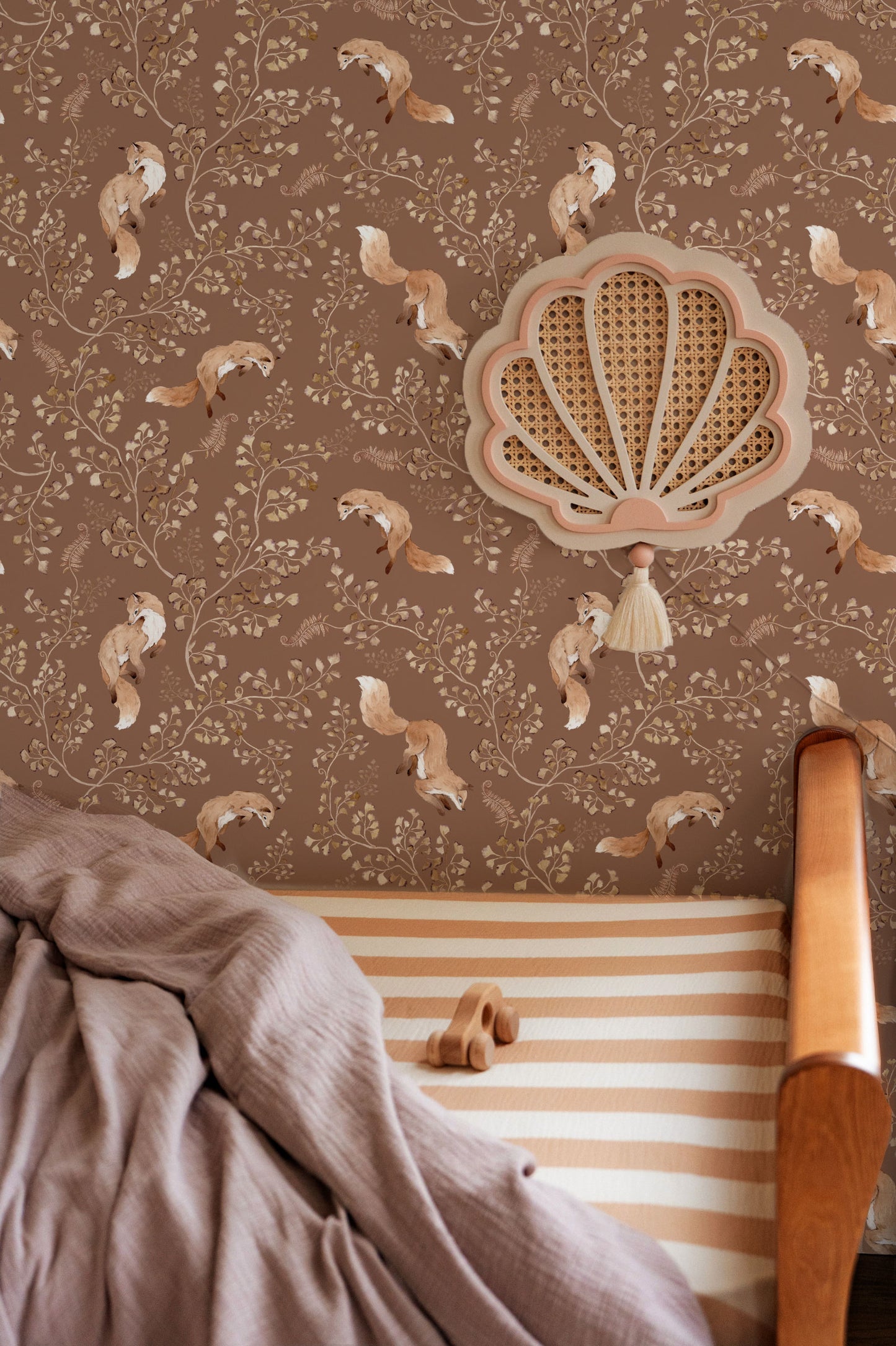 Playful Fox on Light Brown wallpaper styled in a woodland-themed nursery with rattan furniture and soft decor