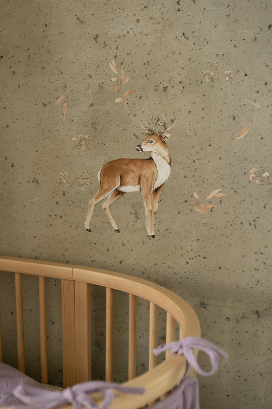 Matuu deer wall sticker above round crib in neutral nursery with green wall