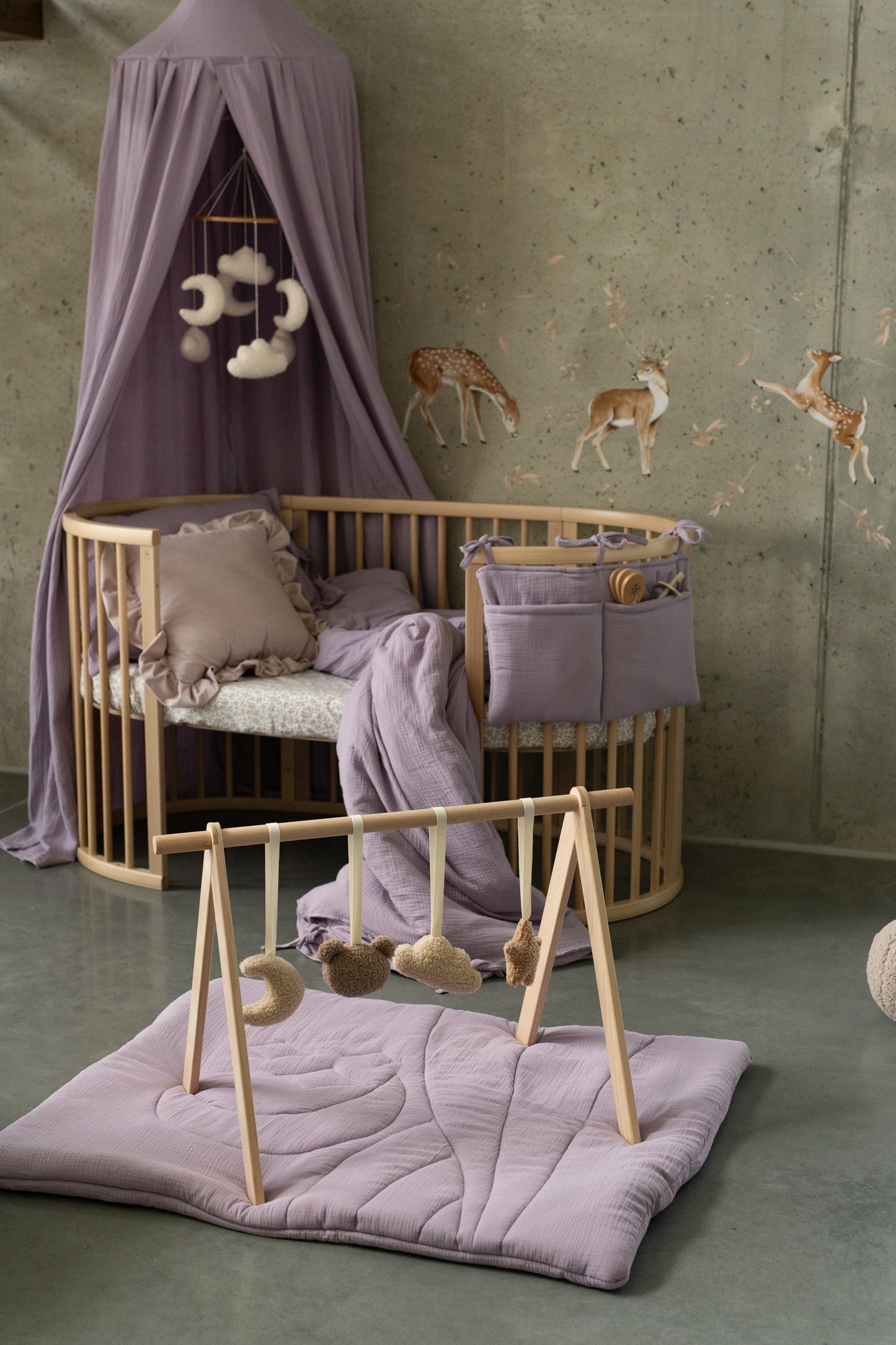 Nature-inspired baby room with Matuu leaping deer wall sticker and neutral textiles.