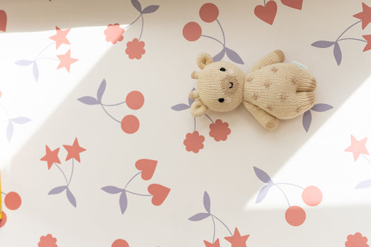 Matuu Heartgarden wallpaper in cream – playful mix of hearts, stars, flowers and cherries with a soft teddy bear