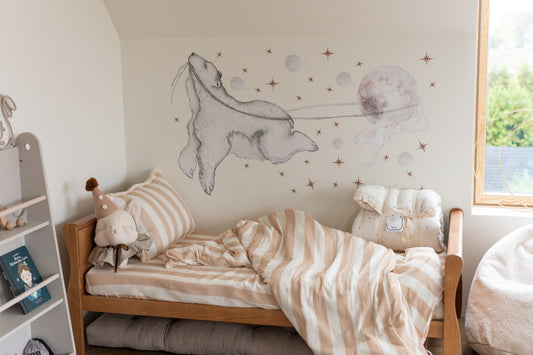 Peaceful kids’ room with Matuu whale wall sticker and striped bedding – calming ocean nursery.