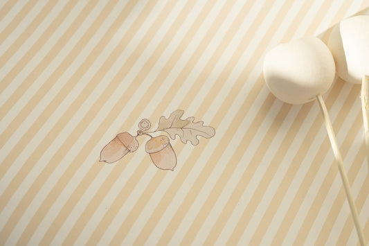 Close-up of Matuu Acorn Stripes yellow wallpaper showing delicate acorn details