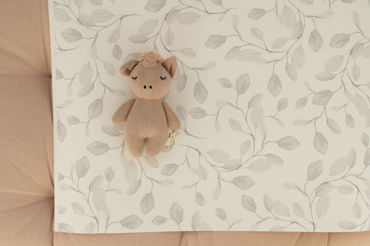 Matuu Eucalyptus Whimsy wallpaper in a cozy children’s room with wicker crib