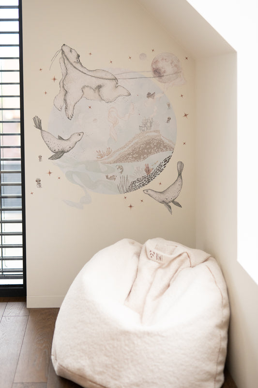 Close-up of Matuu ocean wall decals above crib – soft blue nursery with sea life decor