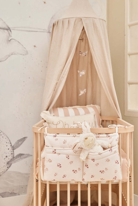 Matuu floral bed pocket – two quilted compartments with delicate cherry blossom pattern, styled with a beige canopy.