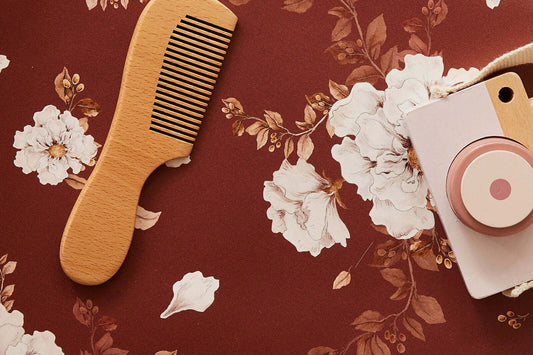 Detail shot of Wild Roses on Red Brown wallpaper featuring hand-painted roses and leaves