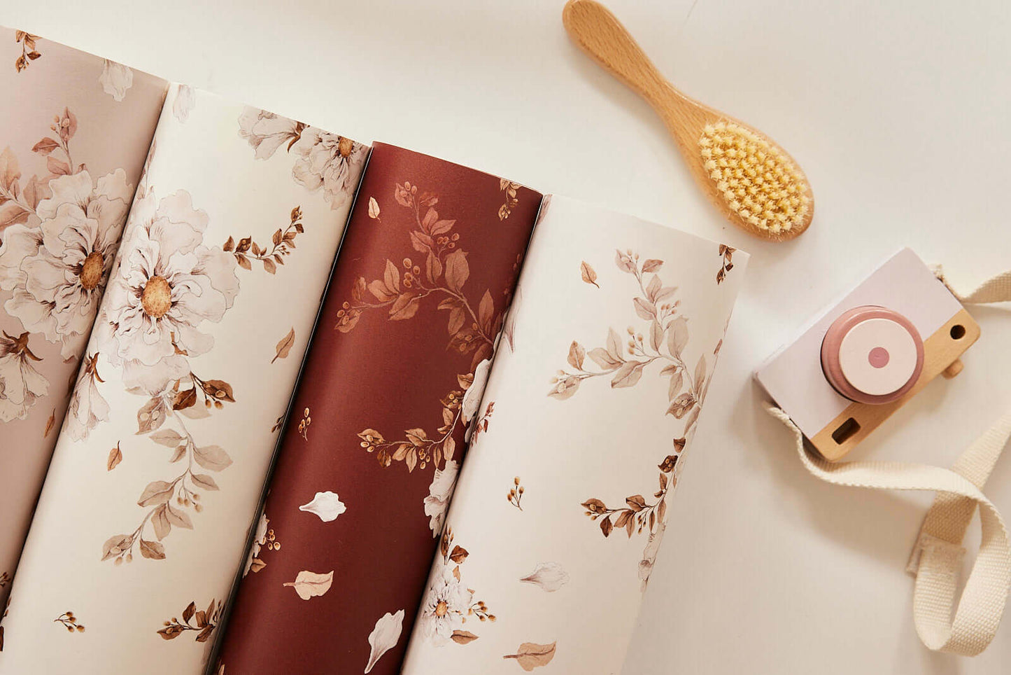Rolled Wild Roses on Dusty Pink wallpaper showing soft pink roses and green leaves – Matuu design