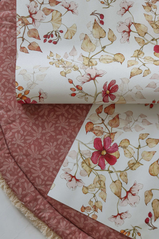 Matuu Indian Summer white wallpaper close-up with rolled samples showing floral details
