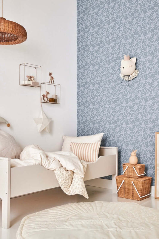 Kids’ room with Matuu Blue Barberries wallpaper and cozy white bedding, botanical theme
