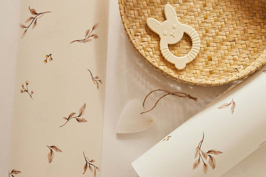 Close-up of Little Leaves on White wallpaper with baby accessories – Matuu botanical design