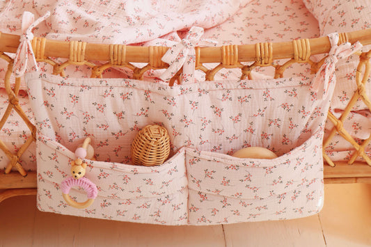 Handmade Matuu pink floral bed pocket with three compartments – functional and decorative.