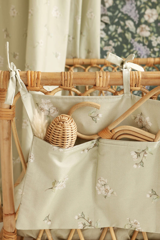 Close-up of Matuu organizer in “Apple Blossom on Green” – gentle floral print on green fabric, perfect for stylish and practical baby storage.
