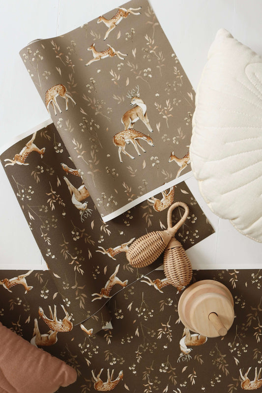 Matuu Deer Glade brown wallpaper rolled-up view with deer and leaf pattern visible