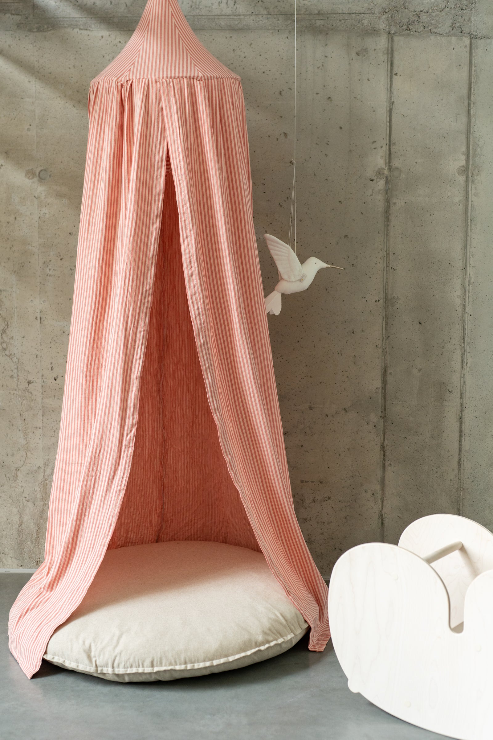 Matuu Blush Stripes muslin canopy styled over round play mat – cozy corner for reading