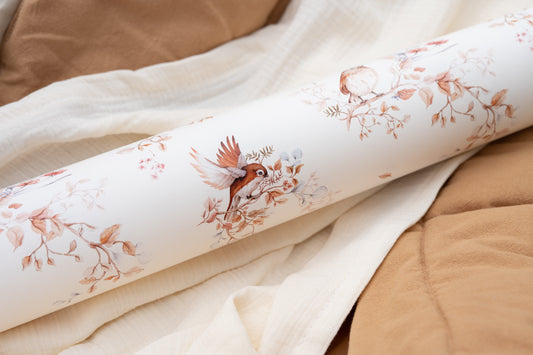 Close-up of folded Matuu Brunch on Branches wallpaper with birds and subtle floral design in warm neutrals (small size)